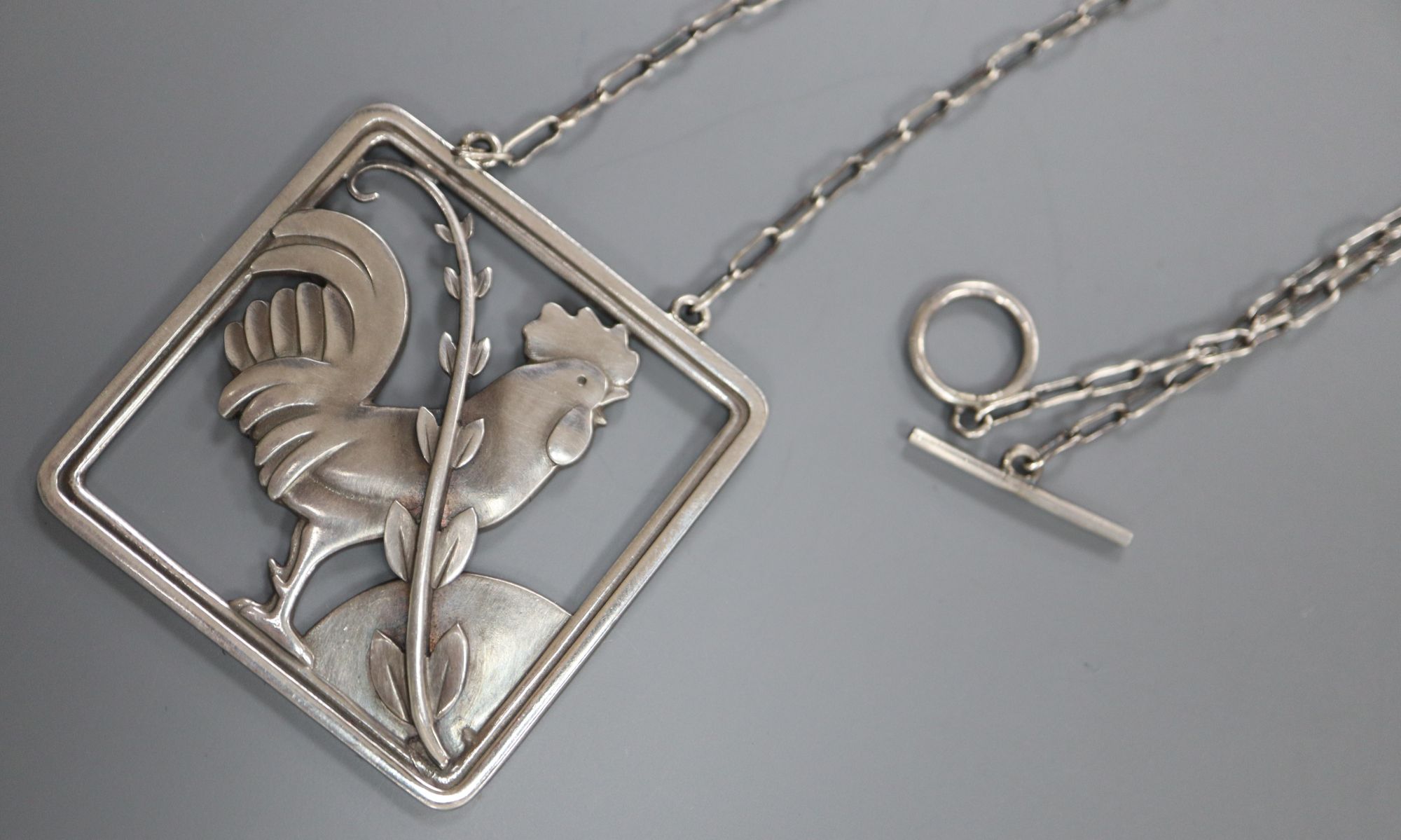 A Georg Jensen sterling Cockerel and foliate spray square pendant on chain, no. 96, pendant 38mm.